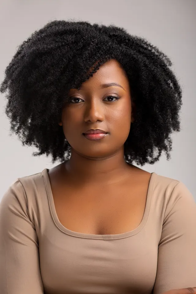Modelo a usar a peruca Afro Café Volume leve, acabamento natural